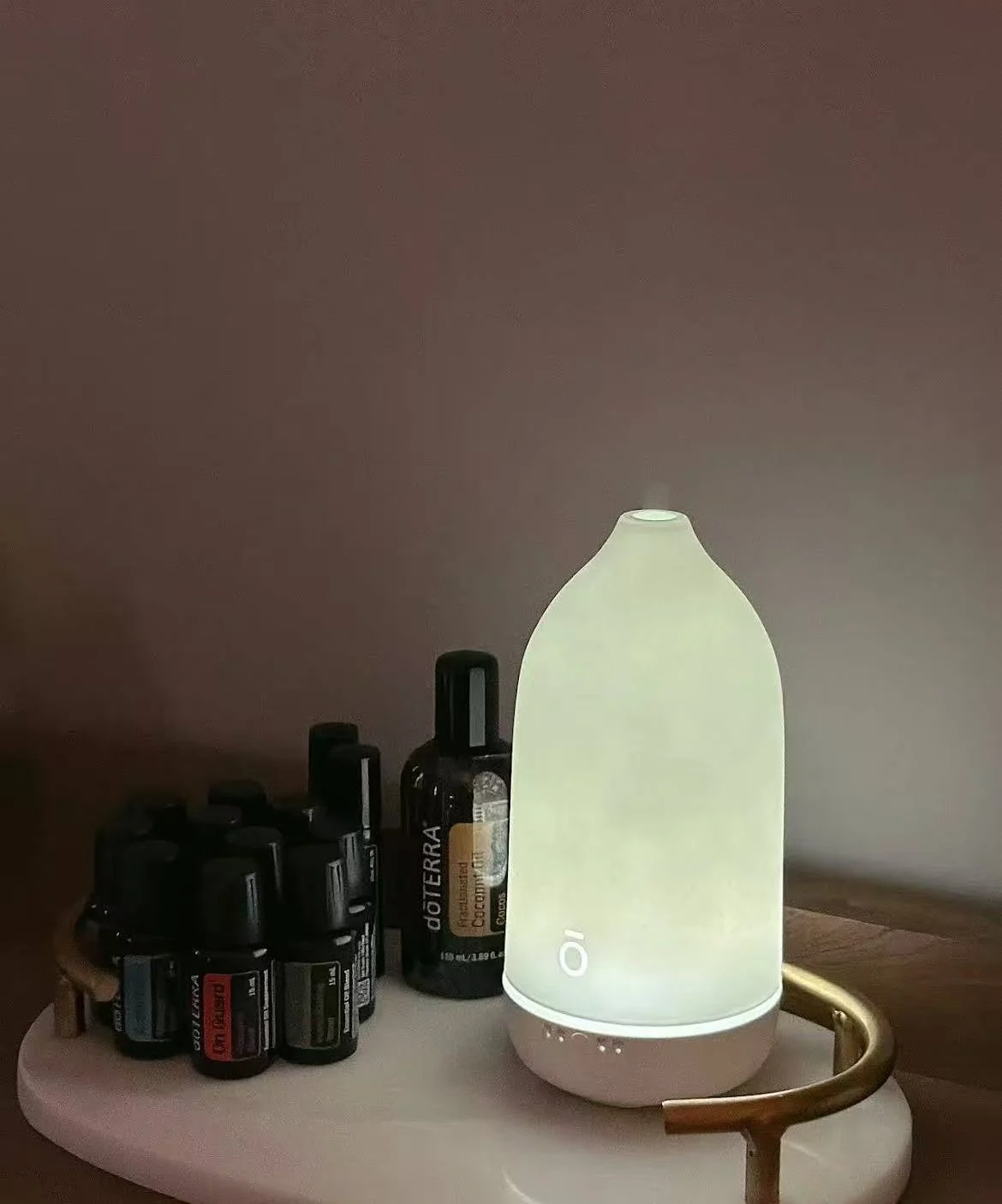 A softly lit aroma diffuser with essential oils