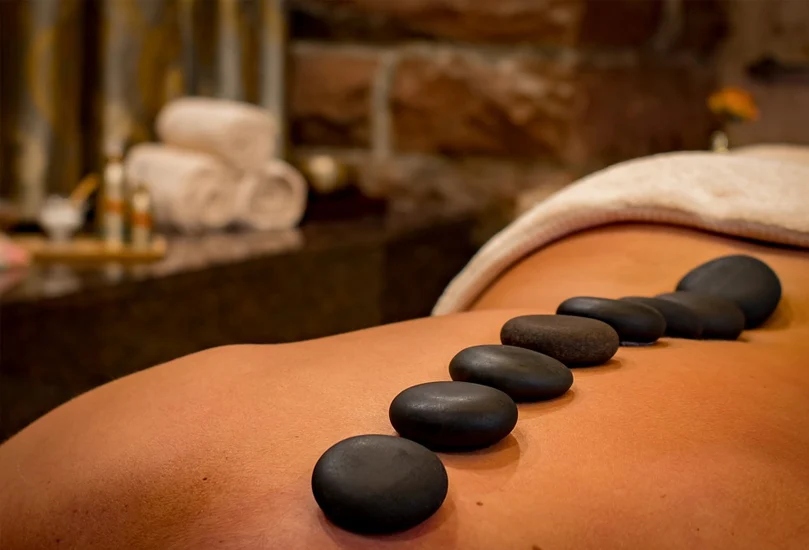 Warm stones prepared for a wellness session